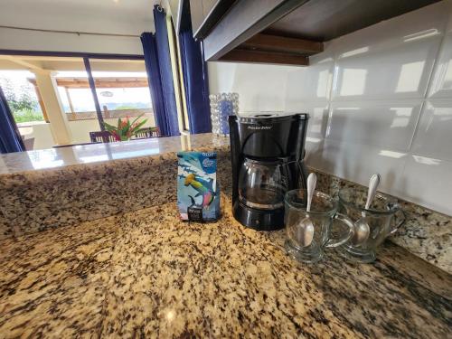 a coffee maker sitting on top of a counter at Amazing Oceanview rooftop terrace walk to beach in Coco