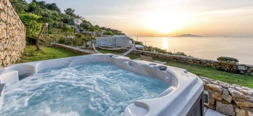 a jacuzzi tub with a view of the ocean at Villa DAlessandro in Anacapri