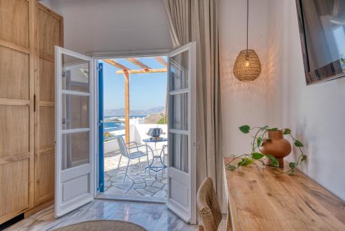 a room with a door open to a patio with a view at San Antonio Summerland in Mýkonos City