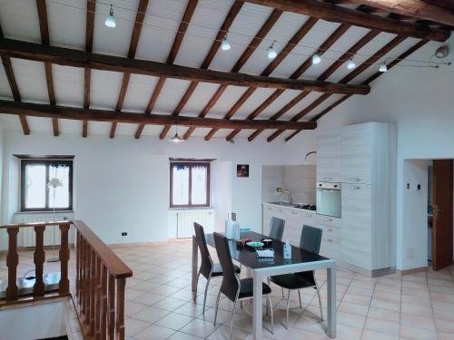 a kitchen and dining room with a table and chairs at Francigena Viterbo Apartment in Viterbo