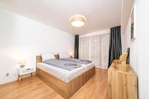 a bedroom with a bed and a desk in a room at Cozy Stay 2bdrm Central Apartment in Varna City