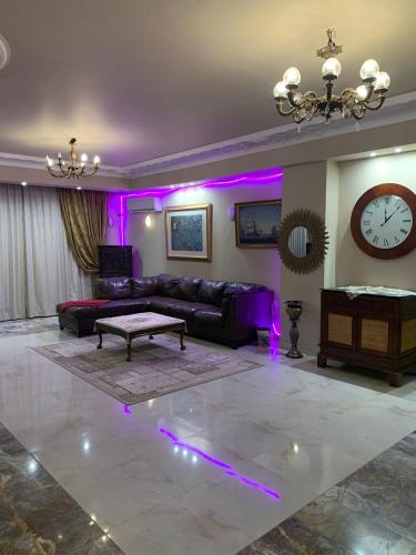 a living room with a couch and purple lighting at فيلا 
