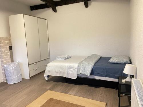 a small bedroom with a bed and a cabinet at Villa med 5 sovrum in Gothenburg
