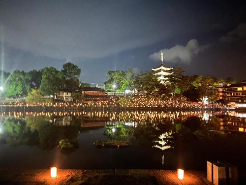 a view of a city at night with lights at Dormitory Omitsu in Nara