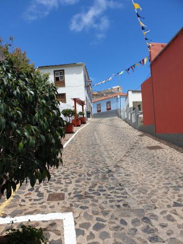 a cobblestone street in a town with flags at Casa Marcos in La Gomera with relaxing terrace in Agulo