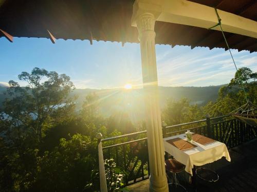 a view from the porch of a house with the sun setting at Berghaus Bungalow in Ella