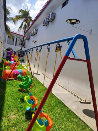 a group of swings in a playground at Hotel El Bosque in Jaén