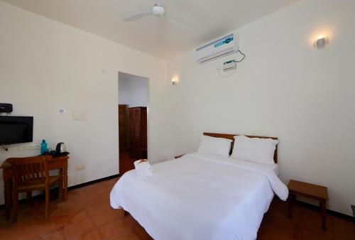 Ένα ή περισσότερα κρεβάτια σε δωμάτιο στο Paraikal Beach Resort