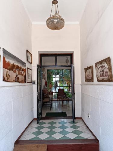 a hallway with a door leading to a dining room at La Cara Oculta de Salta Bed and Breakfast in Salta
