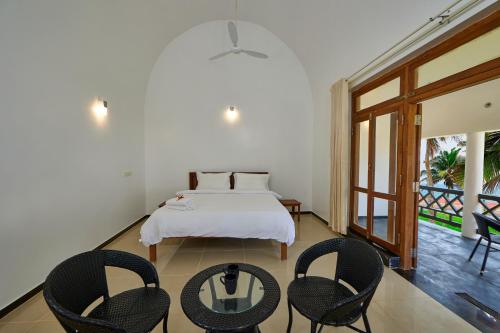 Ένα ή περισσότερα κρεβάτια σε δωμάτιο στο Paraikal Beach Resort
