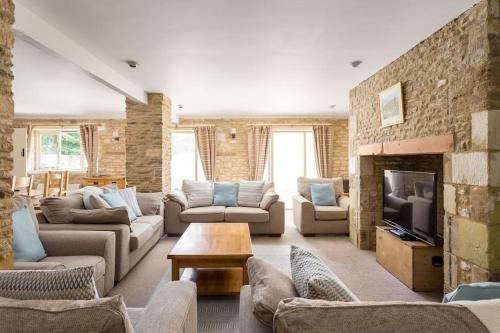 a large living room with couches and a fireplace at Stanton House, 6 bedroom, 5 bath in Cheltenham