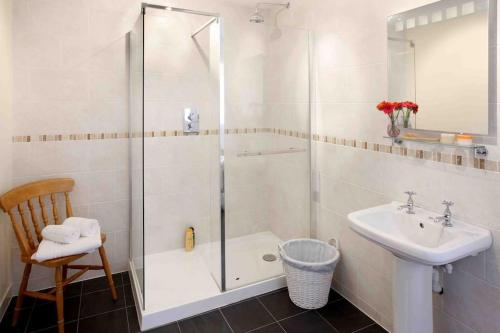 a bathroom with a shower and a sink at Stanton House, 6 bedroom, 5 bath in Cheltenham