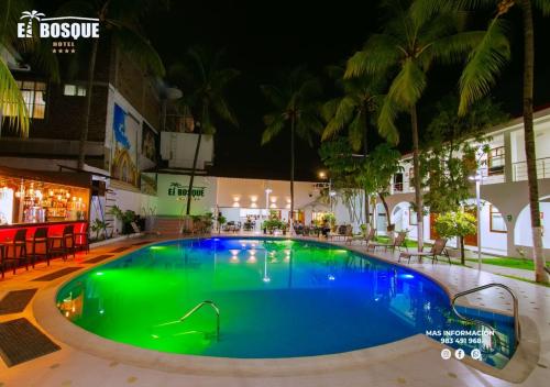 a large swimming pool in the middle of a building at night at Hotel El Bosque in Jaén