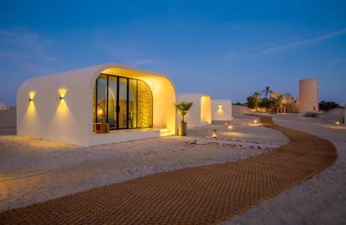 a building in the middle of the desert at night at Terra Solis Dubai in Dubai