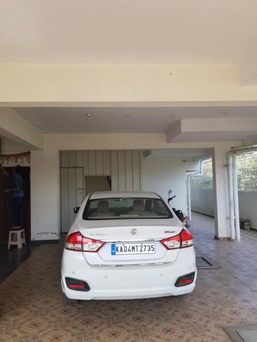a white car parked inside of a garage at Anuraag in Bangalore