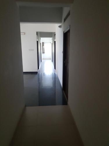 an empty corridor of an empty building with a hallway at Anuraag in Bangalore