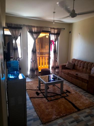 a living room with a couch and a coffee table at Bamburi BnB in Mombasa