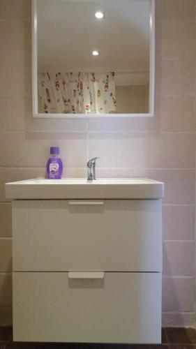 a bathroom with a white sink and a mirror at Le Jardin Aparthotel in Taza