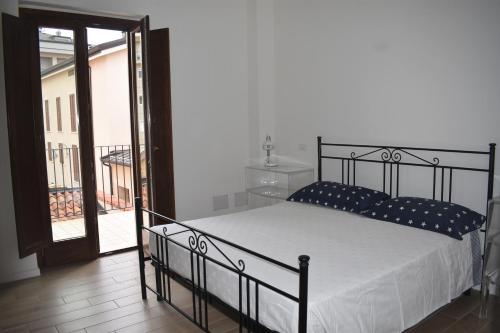 a bedroom with a bed and a sliding glass door at Le Radici Home in LʼAquila