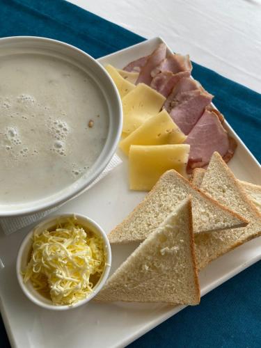 a plate of food with cheese and meats and a bowl of dip at FENIX TOWN in Vinnytsya