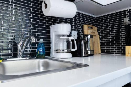 a kitchen counter with a sink and a coffee maker at 69-2D Stylish Lower East Side 1BR Apt BRAND NEW in New York