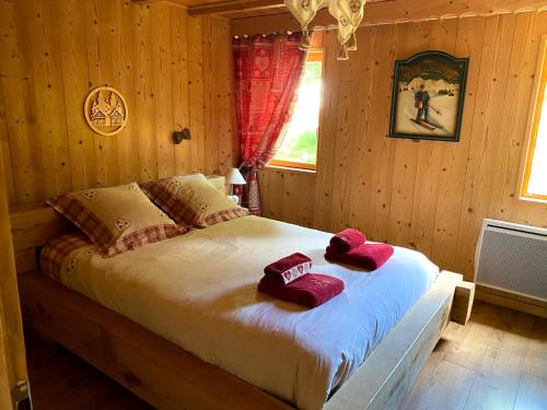 a bedroom with a bed with red towels on it at Chalet d' Annelise in Gérardmer