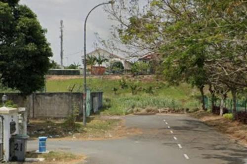 an empty parking lot with a street light and trees at Cozy house with free wifi and parking near Utm, Legoland in Skudai