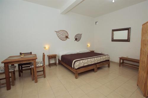 a bedroom with a bed and a table and a tableasteryasteryasteryasteryastery at Casa Amaiur in Huichapan