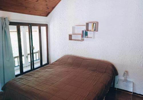 a bedroom with a bed and a large window at 4th Floor Bardonecchia in Bardonecchia