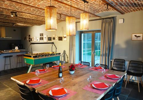 a large dining room with a table and a game at Gîte XXV House - 8 personnes in Héron