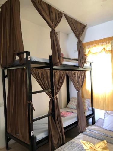 a bedroom with two bunk beds in a room at Hope Inn in Bolod
