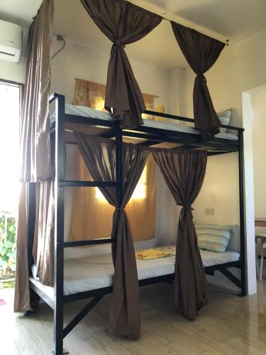 a room with two bunk beds in a room at Hope Inn in Bolod