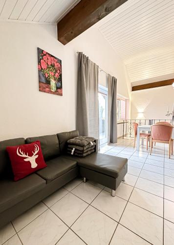 a living room with a couch and a table at Hotel Bergstätter Hof in Immenstadt im Allgäu
