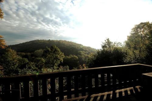 a bench in front of a view of a mountain at De Oranje Kabouter in Durbuy