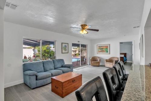 a living room with a blue couch and chairs at 4 bd Near beach spacious solar heated pool waterfront home in Pompano Beach