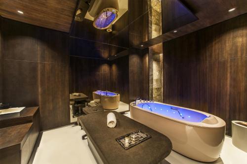a bathroom with a large tub and a sink at Maxx Royal Kemer Resort in Kemer