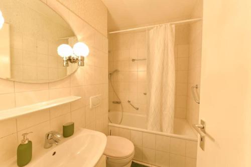 a bathroom with a sink and a toilet and a shower at Comfortable 3 Room apartment, ideal for Messe fair in Hannover