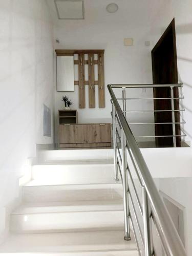 a staircase in a house with white walls at Gold Apartment in Strumica