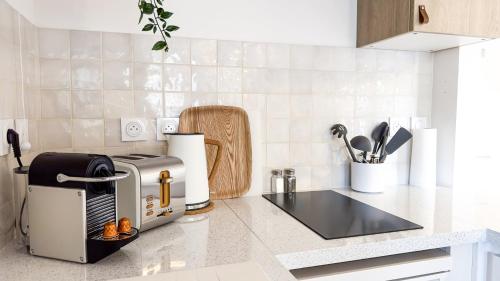 a kitchen with a toaster on a counter at Terracotta by les Appartements Mistretta in Sainte-Maxime