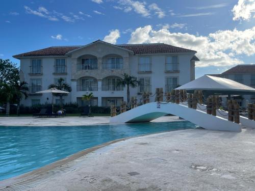 a bridge over the water in front of a building at Hotel Palmera Bayahibe in Bayahibe