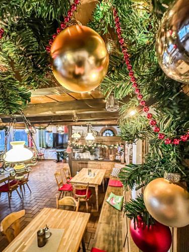 a restaurant with wooden tables and christmas decorations at Hotel Bergstätter Hof in Immenstadt im Allgäu