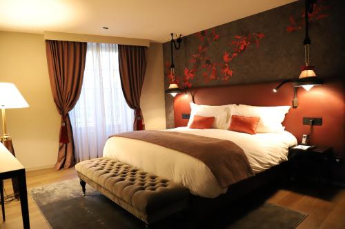 a bedroom with a large bed with a large headboard at Chateau De Germigney in Port-Lesney
