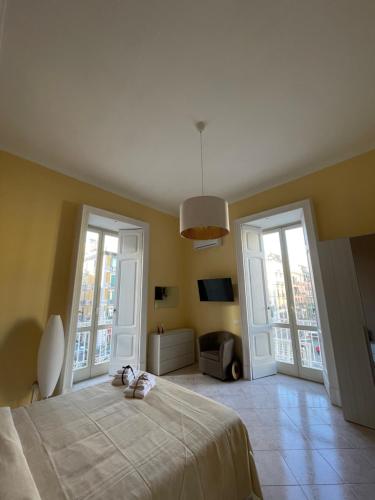 a bedroom with a bed and two large windows at Maria Marì house in Naples