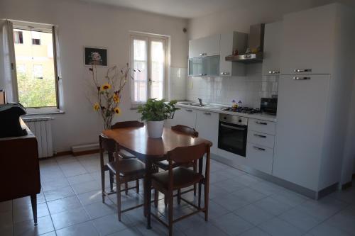 a kitchen with a table and chairs and a refrigerator at La casa di Ale in Arezzo