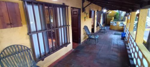 an empty porch of a house with chairs and windows at Villa Margarita in Puerto Colombia