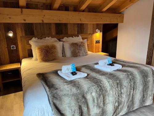 a bedroom with a bed with two towels on it at Chalet Azalée, Montriond, Morzine, Avoriaz in Montriond