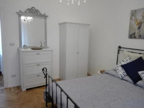 a bedroom with a bed with a dresser and a cabinet at IL SOLE Villino centro storico, giardino, free parking, free Wi-Fi in Venaria Reale