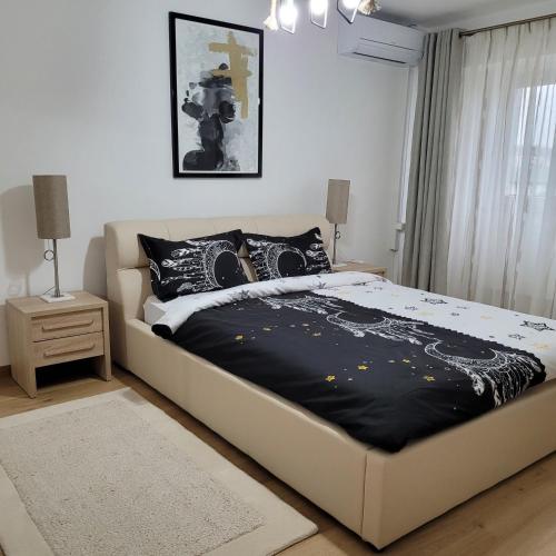 a bedroom with a bed with a black comforter at Apartament Lux - Dorobantilor in Cluj-Napoca