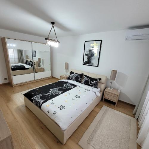 ein Schlafzimmer mit einem großen Bett und einem Spiegel in der Unterkunft Apartament Lux - Dorobantilor in Cluj-Napoca