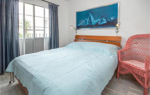 ミハス・コスタにあるAmazing Apartment In Mijas Costa With House A Mountain Viewのベッドルーム1室(ベッド1台、椅子、窓付)